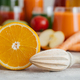 Sliced fresh orange with squeezer. Making juice from fresh fruit. Orange color. - PhotoDune Item for Sale