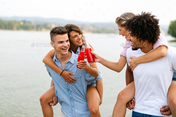 Friends at the beach drinking cocktails having fun on summer vacation - Stock Photo - Images
