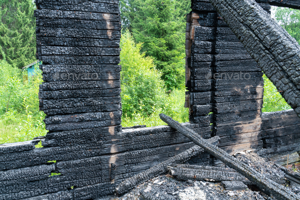 burnt wooden house in the countryside - Stock Photo - Images