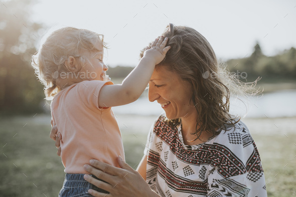Mother and little daughter relaxing in nature - Stock Photo - Images