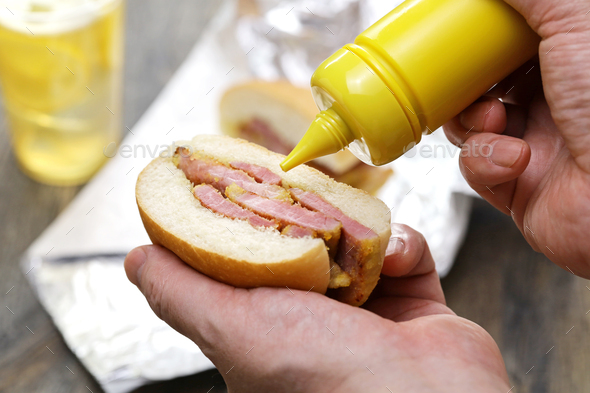 Putting mustard on a peameal bacon sandwich.　　Toronto's signature dish - Stock Photo - Images