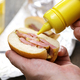 Putting mustard on a peameal bacon sandwich.　　Toronto&#39;s signature dish - PhotoDune Item for Sale