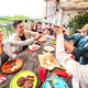 Wide angle view of fancy people toasting red wine together at pic nic party in open air villa - PhotoDune Item for Sale