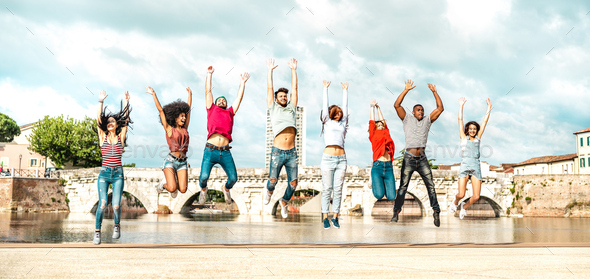 Diverse multi racial friends jumping at Rimini city - Stock Photo - Images
