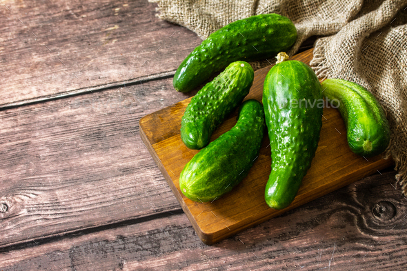 Fresh vegetable. Ugly organic twisted cucumbers on wooden table. Copy space. - Stock Photo - Images