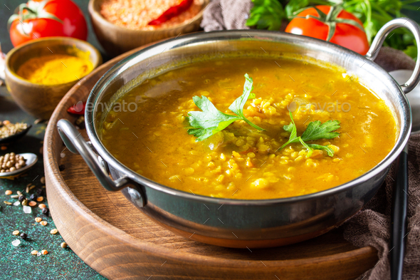 Indian cuisine. Traditional Indian spicy lentil puree soup with herbs on a dark background. - Stock Photo - Images