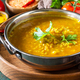 Indian cuisine. Traditional Indian spicy lentil puree soup with herbs on a dark background. - PhotoDune Item for Sale