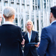 Group of business people talking outside a financial building - PhotoDune Item for Sale