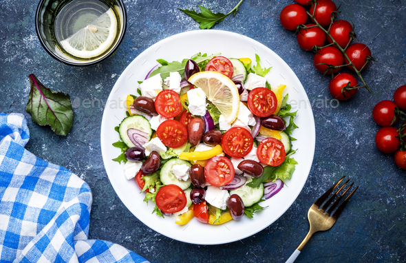 Greek salad with feta cheese, kalamata olives, red tomato, yellow paprika, cucumber and onion - Stock Photo - Images