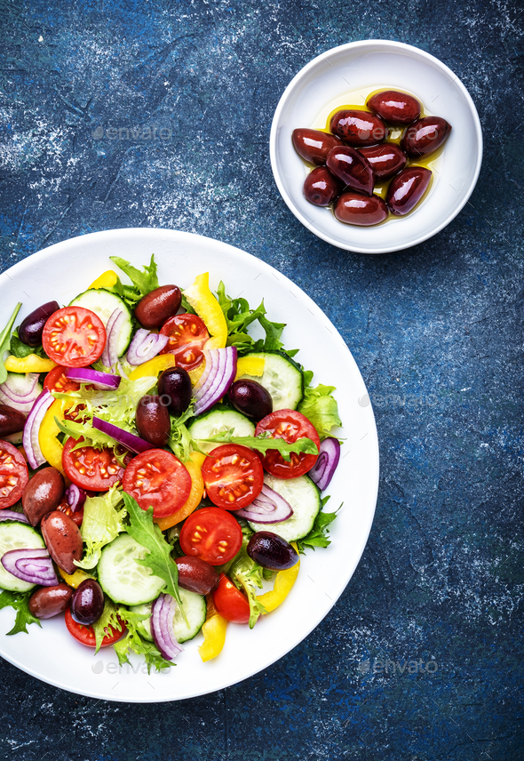 Vegan greek salad with kalamata olives, red tomato, yellow paprika, cucumber  - Stock Photo - Images