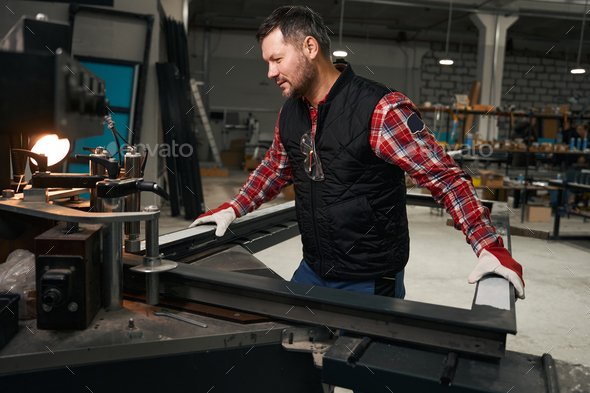 Professional worker working with metal parts constructions - Stock Photo - Images
