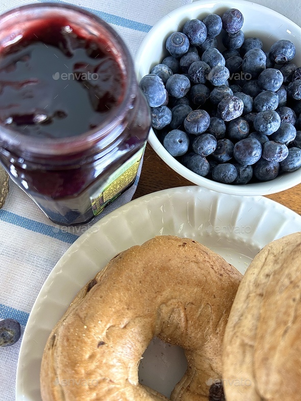 Closeup of blueberry bagels and jam with fresh blueberries - Stock Photo - Images