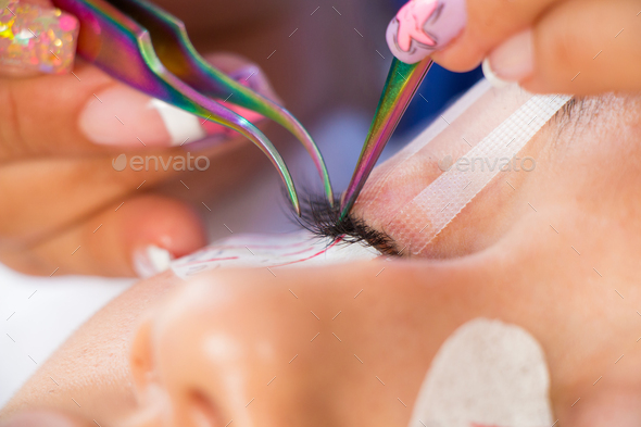 eyelash extension beauty procedure. eyelashes hair to hair. Beauty treatment. false eyelashes