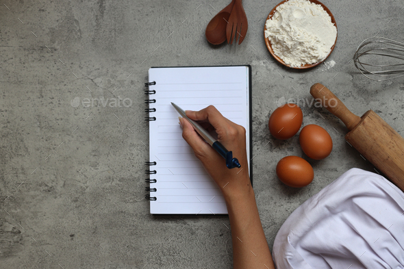 Hand writing on a blank recipe notes - Stock Photo - Images