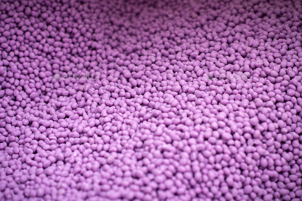 Biodegradable plastic granules texture, plastic polymer pellets color purple
