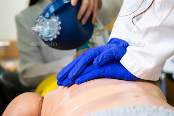 Medical Students practicing emergency cardiopulmonary resuscitation on a medical practice doll