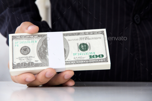 Hand giving money - Stock Photo - Images
