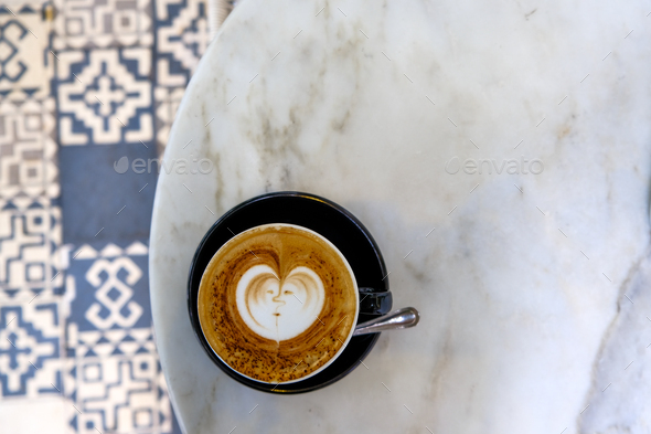 Top view of black cup of tasty cappuccino with latte art on marble table background. - Stock Photo - Images