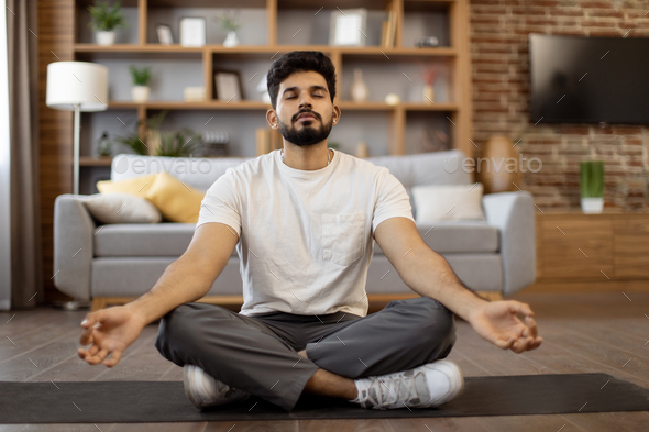 Peaceful young man meditating in lotus position Vector Image