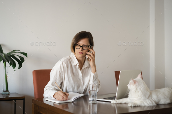 Serious middle-aged business woman wearing eyeglasses, white linen shirt with long straight hair