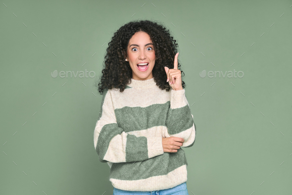 Excited young latin woman pointing finger up getting new idea isolated on green. - Stock Photo - Images