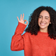 Young happy latin woman showing ok sign isolated on blue background. - PhotoDune Item for Sale