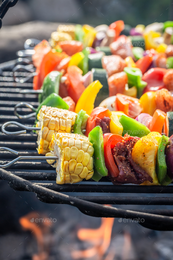 Hot and tasty skewers on grill made of healthy ingredients. - Stock Photo - Images