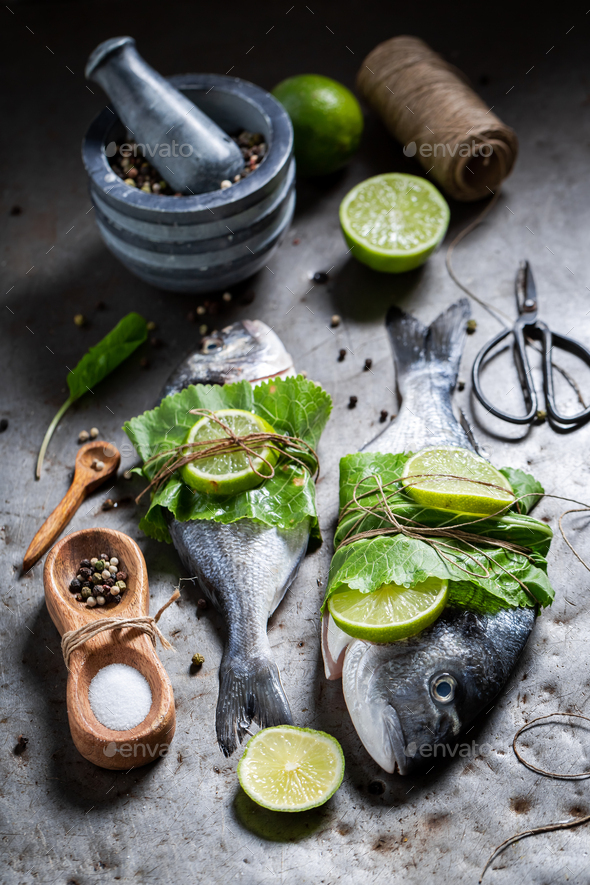 Seasoning freshl fish with lemon, salt and horseradish. - Stock Photo - Images