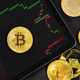 Bitcoin on digital tablet with exchange graph by crypto coins - PhotoDune Item for Sale