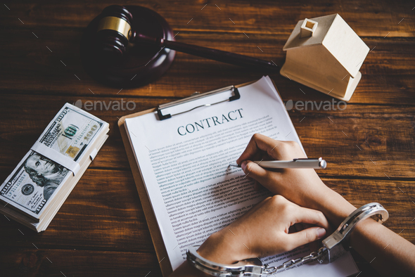 The hand was handcuffed by writing a contract, the concept was forced to be unfair in the contract. - Stock Photo - Images