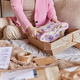 Cropped shot of unrecognizable woman prepares parcel for shipment folds jumper uses skotch wears - PhotoDune Item for Sale