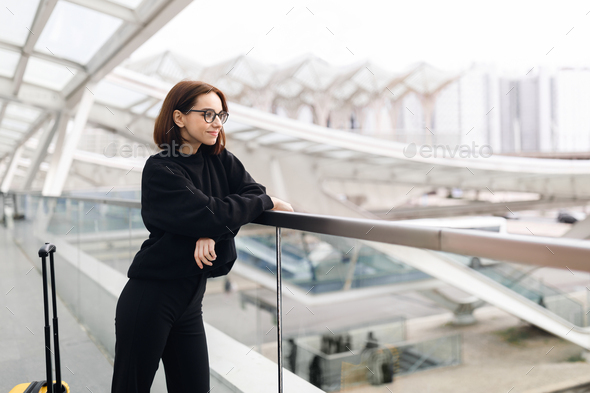 Portrait Of Smiling Young Woman Standing At Airport Terrace - Stock Photo - Images