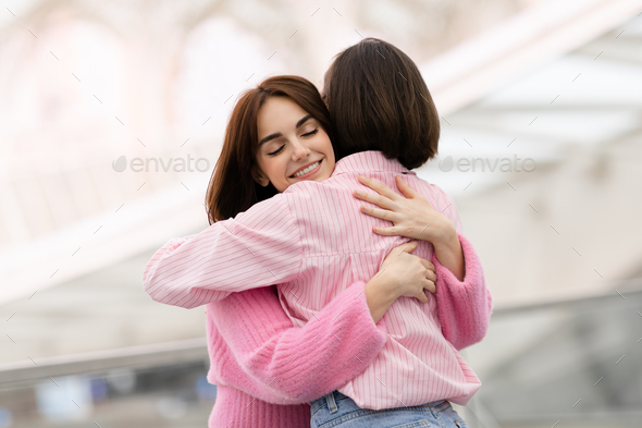 Happy Young Woman Hugging Her Female Friend At Airport Hall, Closeup Shot - Stock Photo - Images