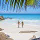 Anse Lazio Praslin Seychelles, young couple men and woman on a tropical beach during a luxury - PhotoDune Item for Sale