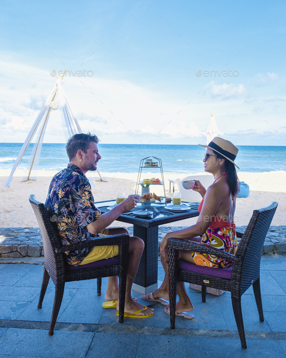 Breakfast on the beach in Phuket Thailand, Luxury breakfast table with food and beautiful tropical - Stock Photo - Images