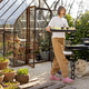 Female gardener with a seedling tray in beautiful garden - PhotoDune Item for Sale