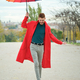 Latin young man with a red coat and rainbow umbrella walking on balance. - PhotoDune Item for Sale