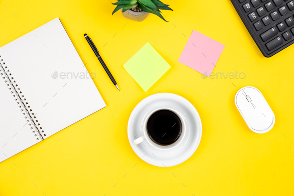 Flat lay, yellow background with coffee cup and notepad. - Stock Photo - Images