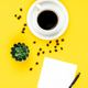 Cup of coffee, paper and coffee beans on a yellow background, flat lay. - PhotoDune Item for Sale