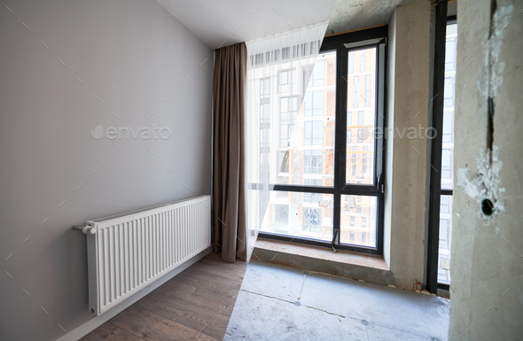 Apartment with large windows before and after renovation.