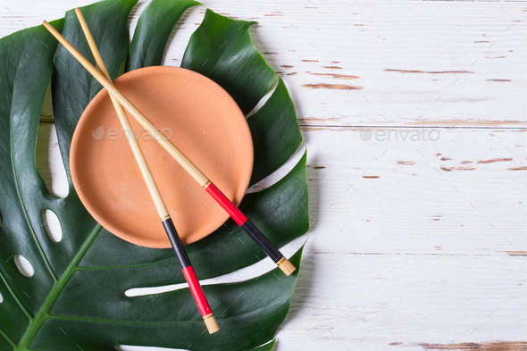Chopstick and ceramic handmade dish. Asian food concept.