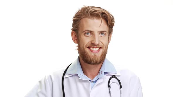 Confident Caucasian Male Doctor with Light Beard Wearing Medical Overall Showing Ok with Fingers on alt