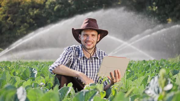 Portrait of Happy Farmer Using Digital Tablet alt