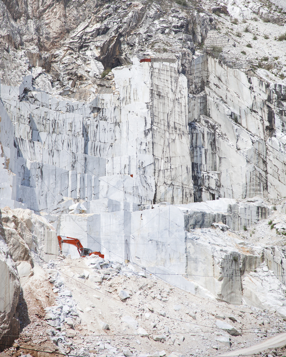 Carrara white marble quarry and an excavator. Tuscany. Italy - Stock Photo - Images