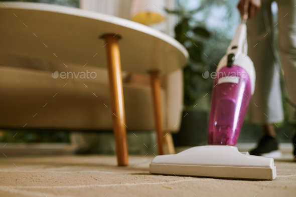 Housewife cleaning table Stock Photo by DragonImages