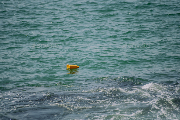 Close up of floating trash in sea.