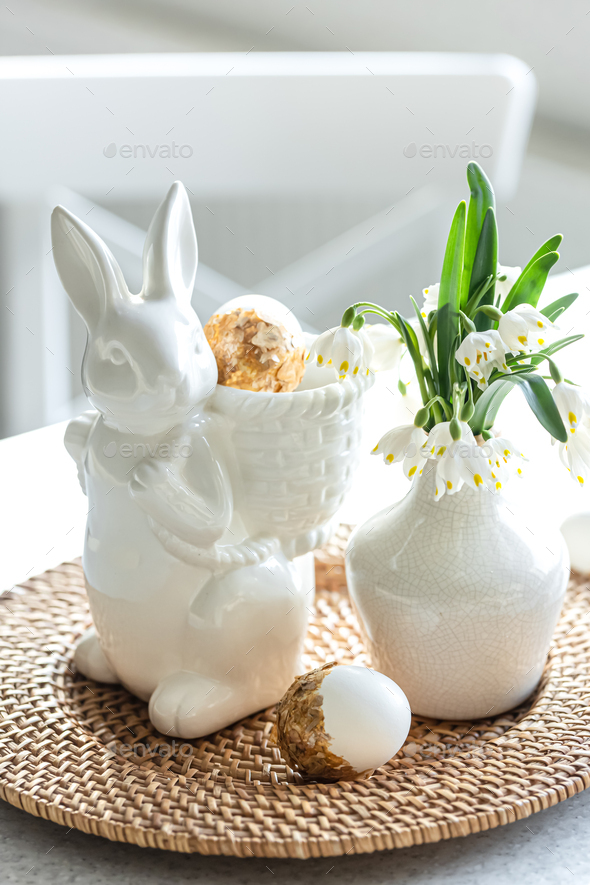 Easter still life with a ceramic hare, eggs and flowers. - Stock Photo - Images