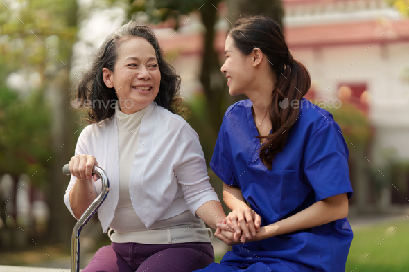 Healthcare nurse, physical therapy with elderly woman at outdoor. Nurse holding hand and help - Stock Photo - Images