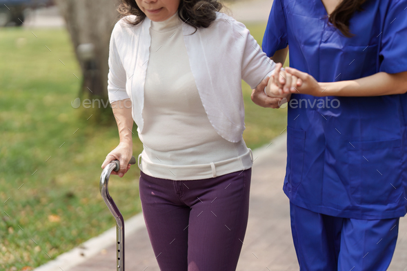 Healthcare nurse, physical therapy with elderly woman at outdoor. Nurse holding hand and help - Stock Photo - Images