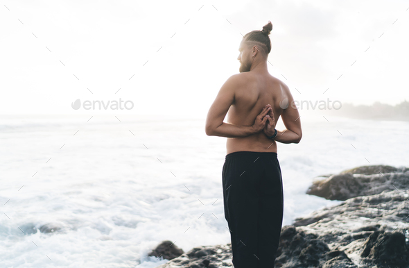  calm male healing during holistic therapy and retreat in yoga pose for vitality